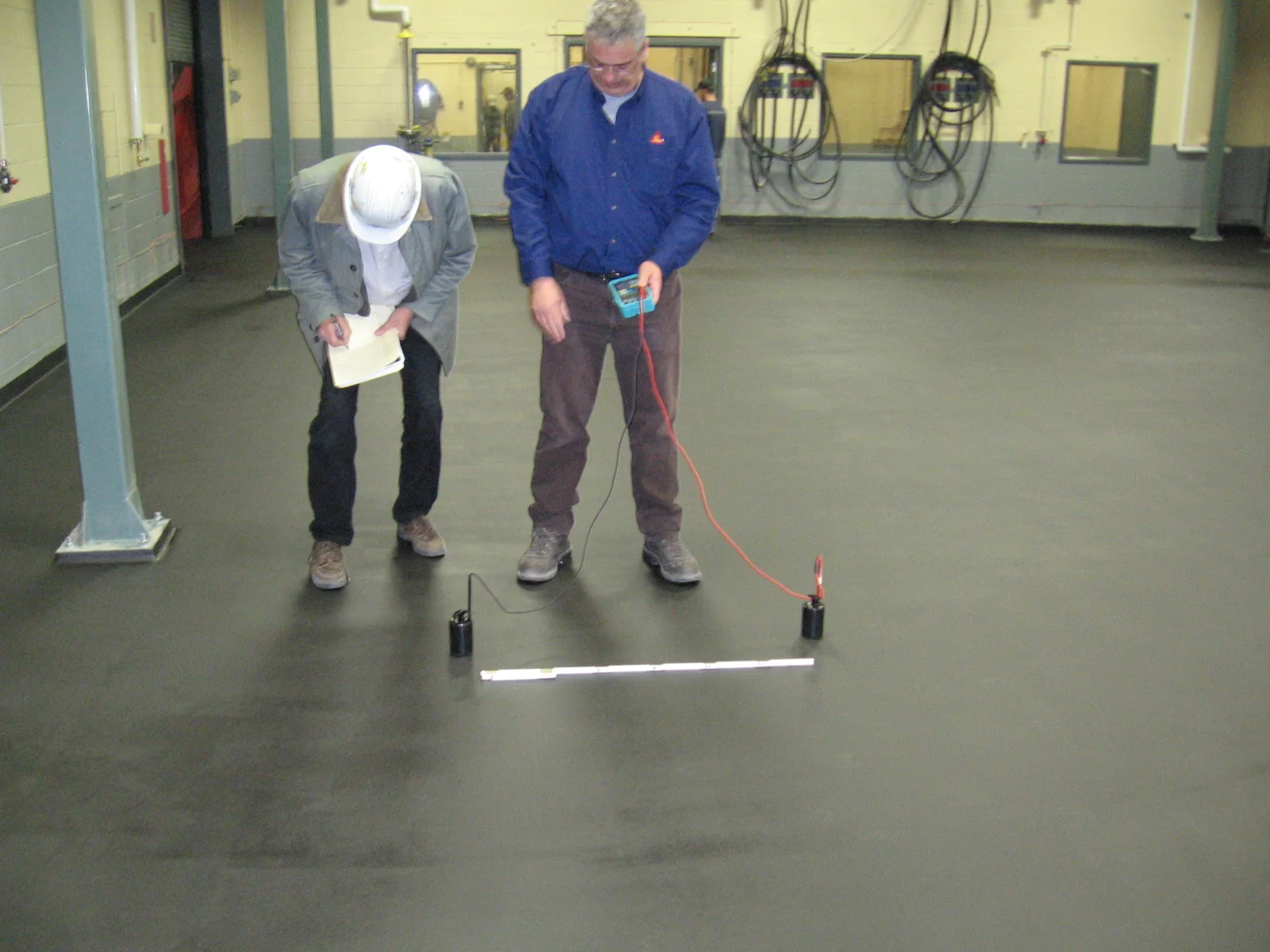 Floor resistance testing at a submarine battery plant in Halifax, Nova Scotia