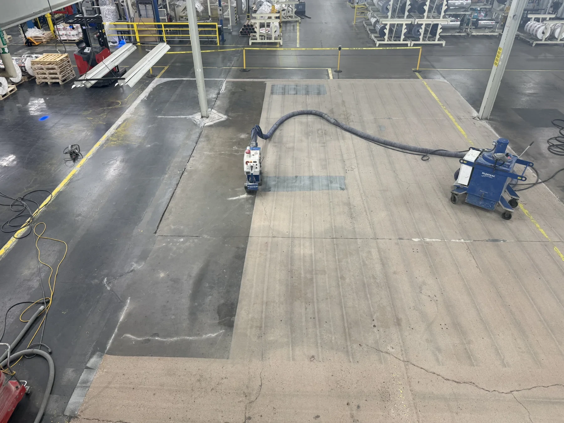 Shot-blasting equipment preparing the concrete floor at a packaging plant in Amherst, Nova Scotia